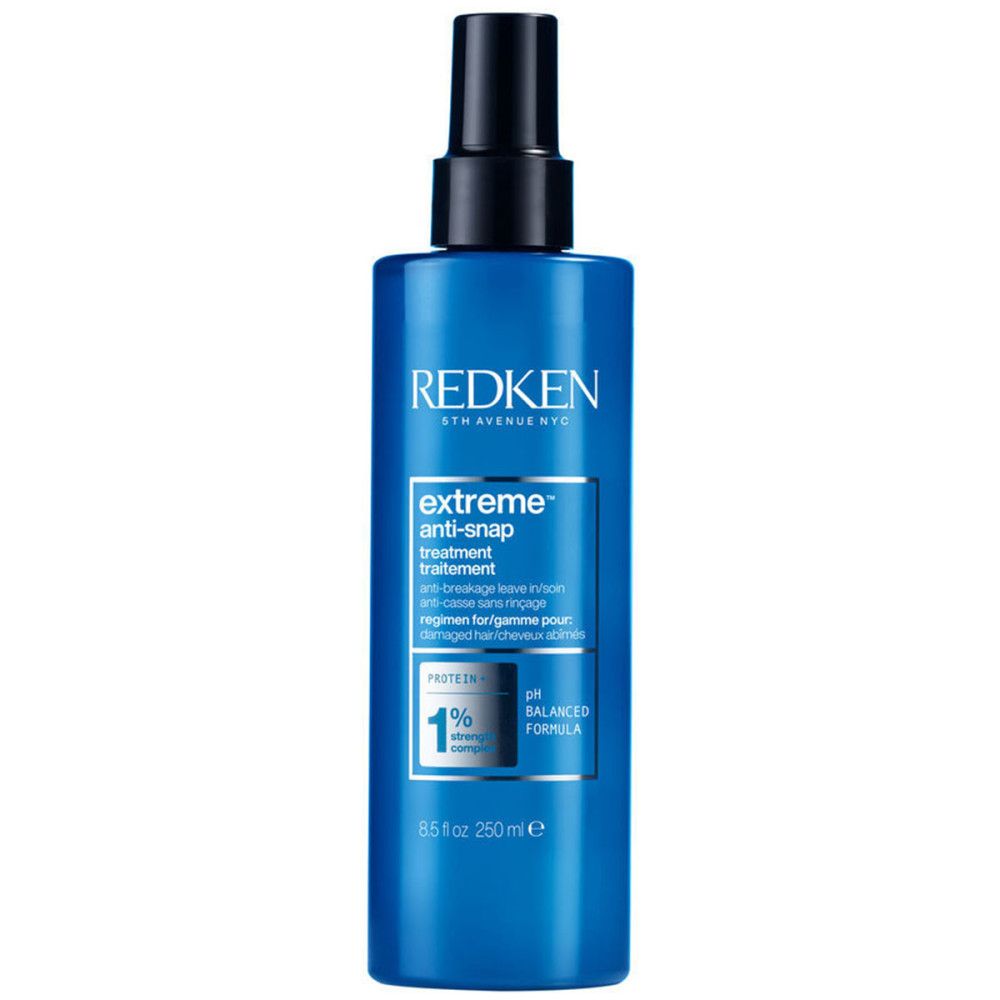 Redken Extreme Anti-Snap Treatment. Blauwe fles met zwarte spraykop. Tekst: Anti-Snap, pH-gebalanceerde formule, 1% sterkte.