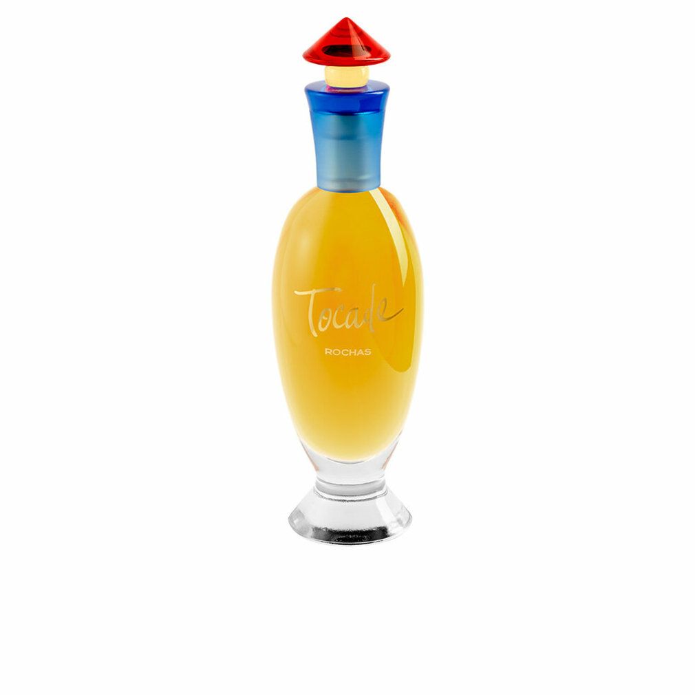 Flacon de parfum avec col bleu et bouchon rouge. Inscription "TOCADE" et "ROCHAS". Flacon transparent.