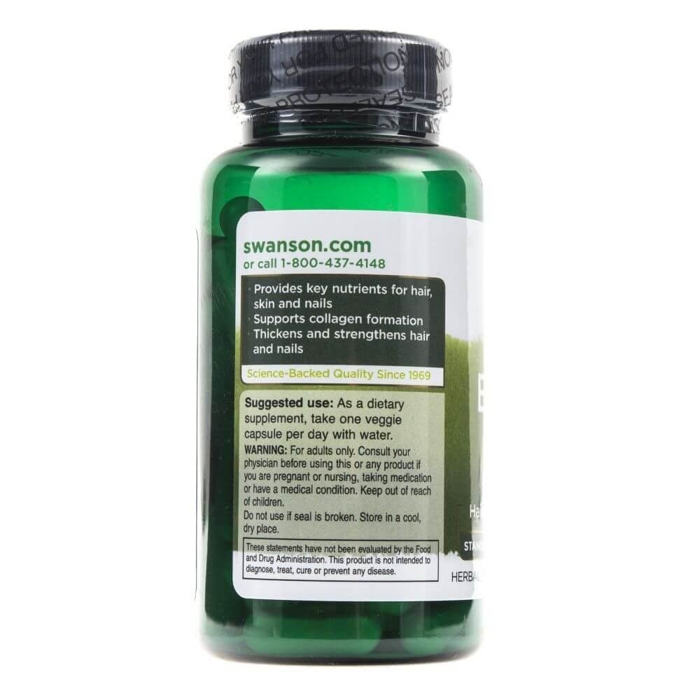 Groene fles van Swanson met etiket met voedingsstoffen voor haar, huid en nagels.