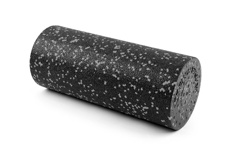 Rouleau de fascia cylindrique noir avec des points blancs. Sur fond blanc.