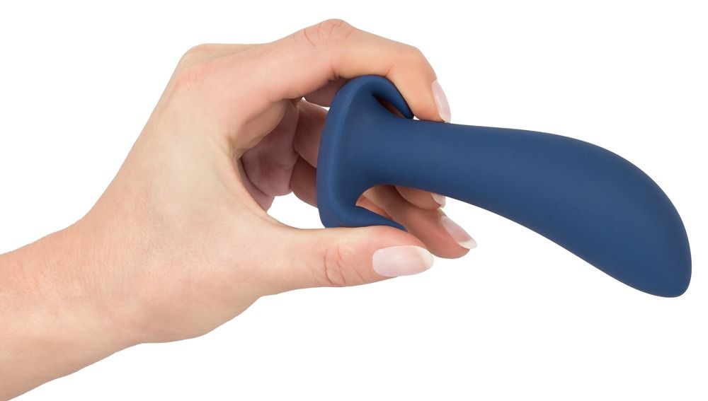 Hand die een donkerblauwe anale plug vasthoudt. Gebogen vorm, brede basis.