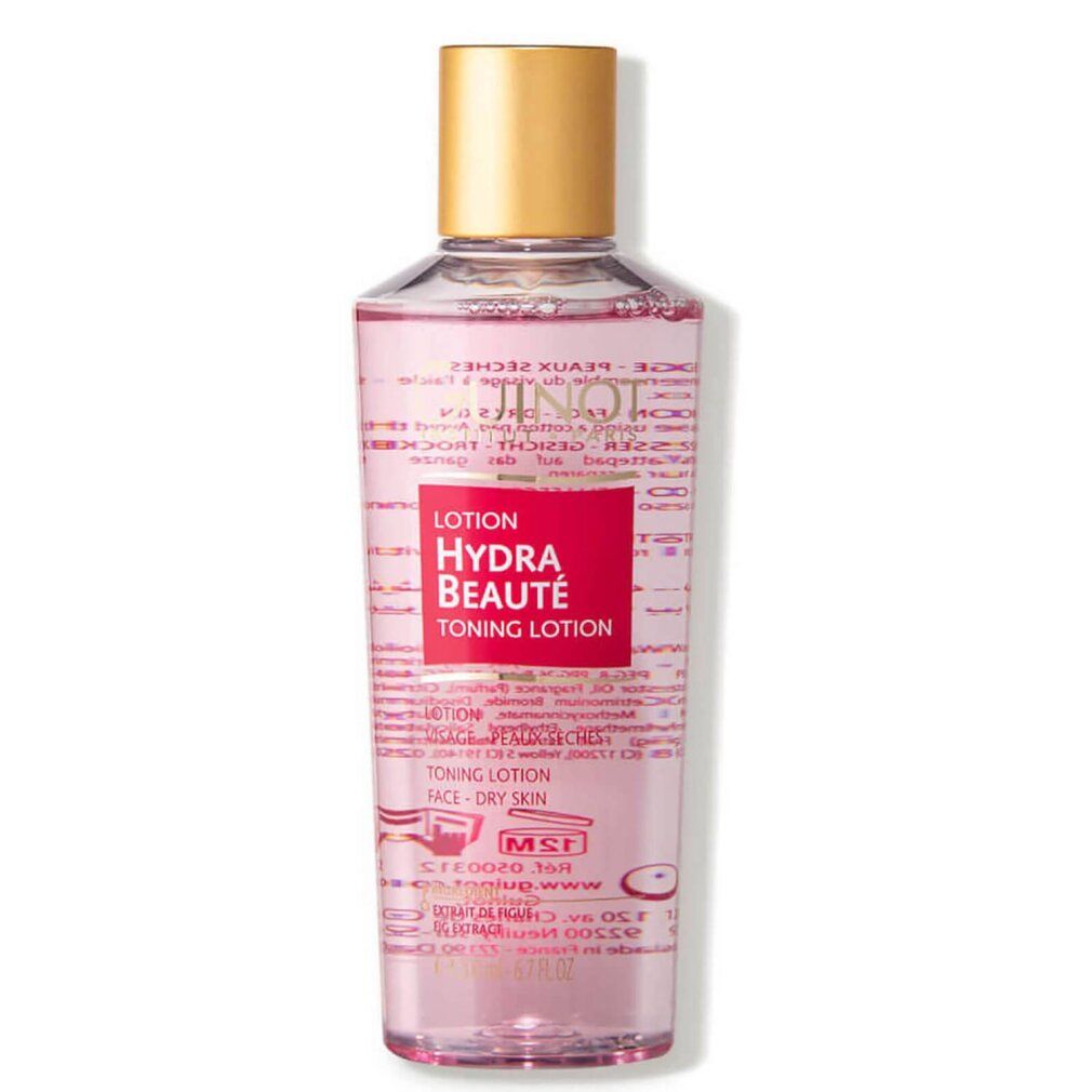 Guinot Hydra Beaute Lotion. Transparante fles met roze vloeistof, gouden dop. Rood etiket met productnaam.