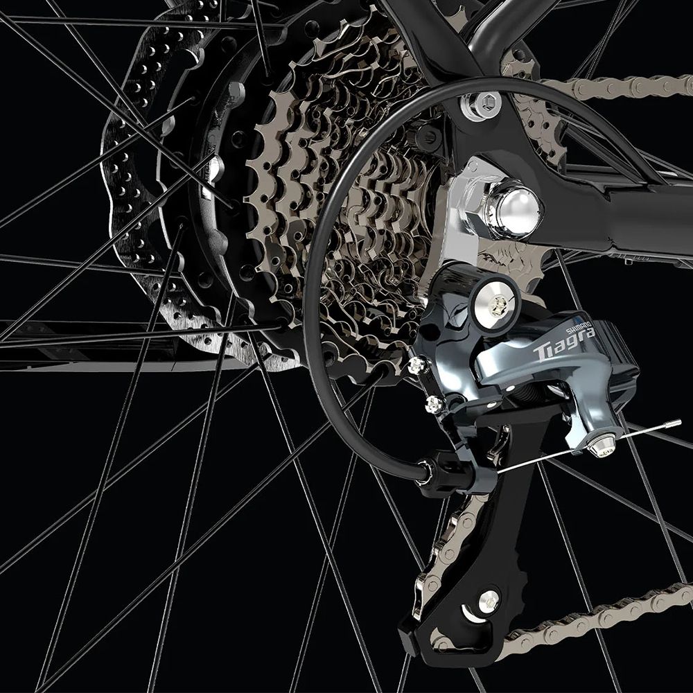 Close-up van de achterderailleur. Tiagra derailleur, zilverkleurig. Zwarte ketting en onderdelen.