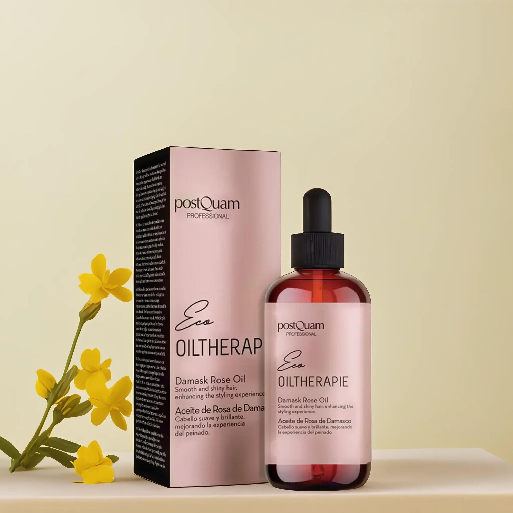 Bruine glazen fles met druppelaar en roze etiket. Daarnaast een roze verpakking met tekst en gele bloemen. Productnaam: Damask rozenolie.