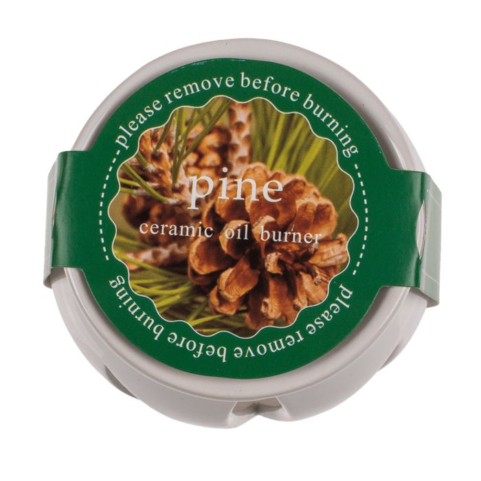 Ronde geurmelt-container met groen etiket. Opschrift 'Pine' en 'ceramic oil burner'. 'Verwijder voor het branden'.