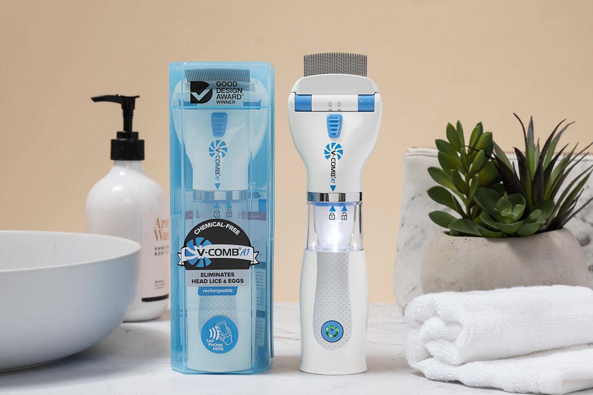 Appareil V-Comb blanc et bleu avec peigne et lumière intégrée. À côté, l'emballage avec informations produit.