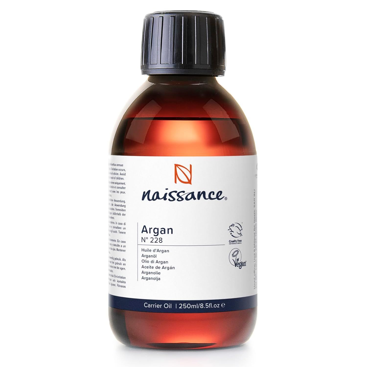 Flacon en verre brun avec bouchon noir. Étiquette avec "Naissance" et "Argan" en plusieurs langues. Label végétalien.