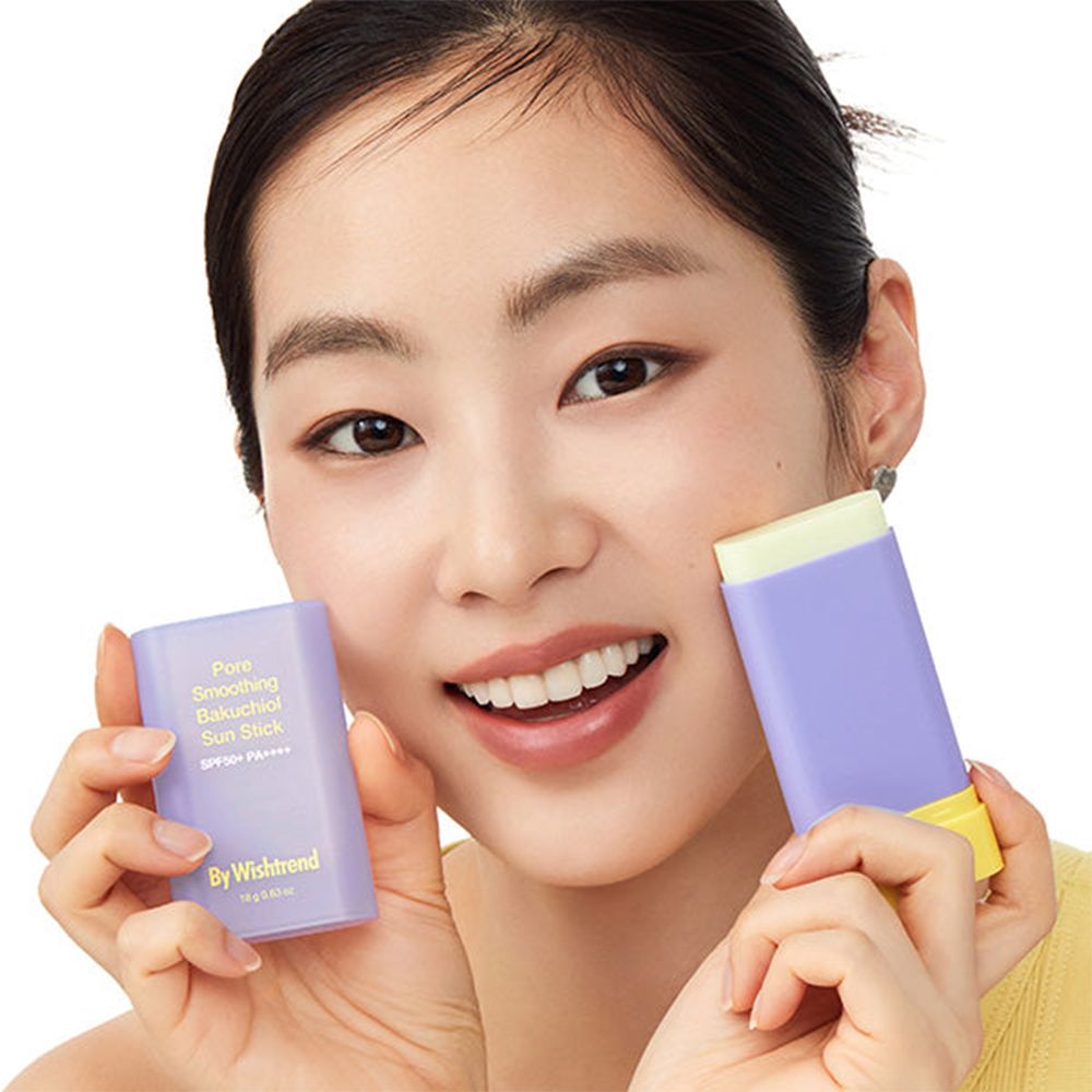 Femme tenant deux sticks solaires violets et jaunes. Texte : Pore Smoothing Bakuchiol Sun Stick, SPF50+ PA++++, By Wishtrend.