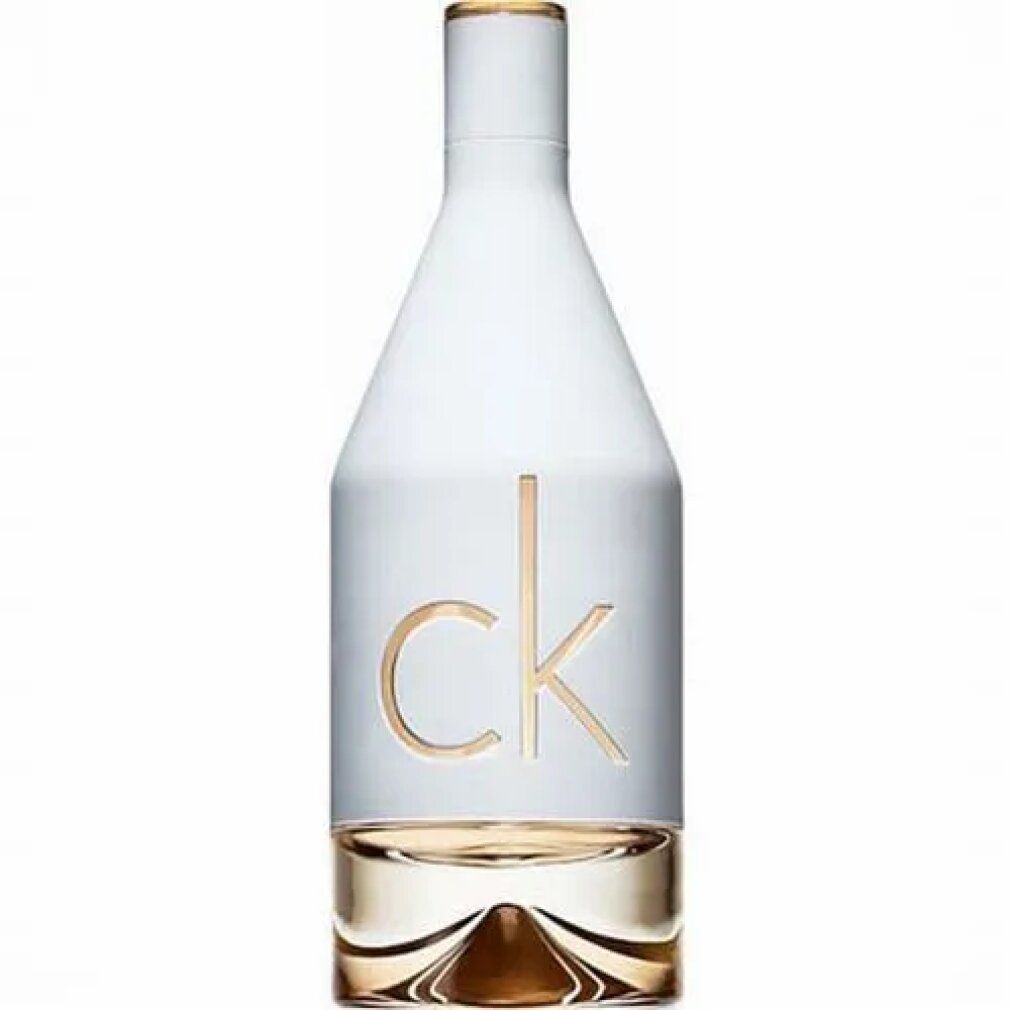 Flacon de parfum blanc avec lettrage doré. Flacon avec liquide clair.