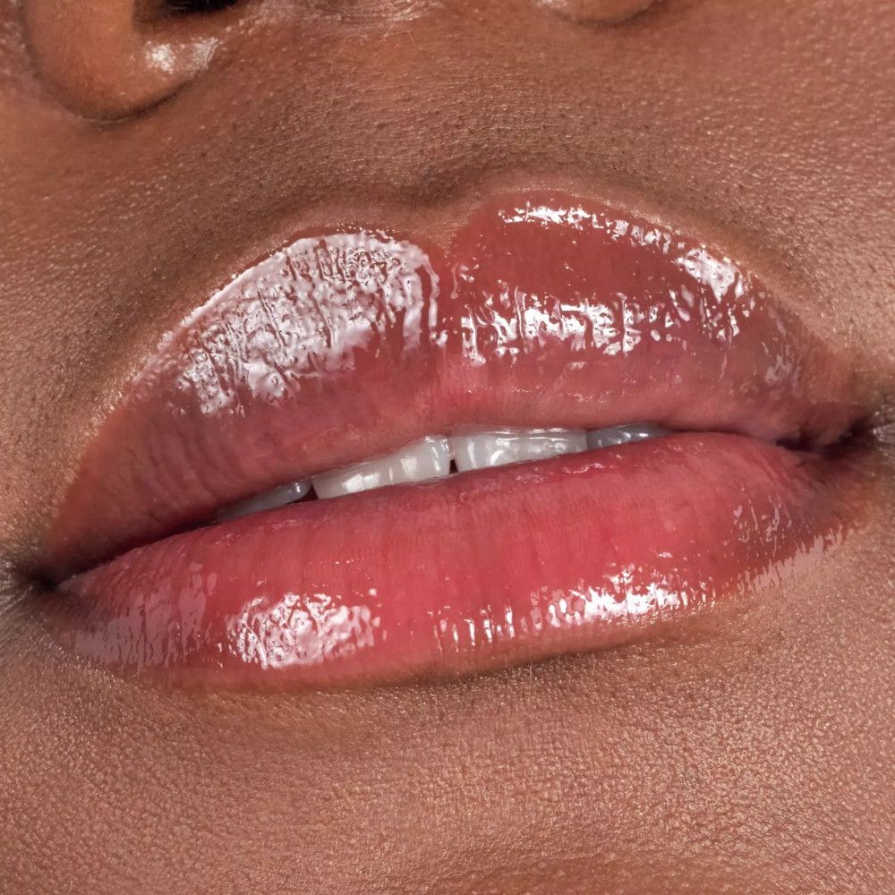Close-up van lippen met glanzende lipgloss. Roze tint.