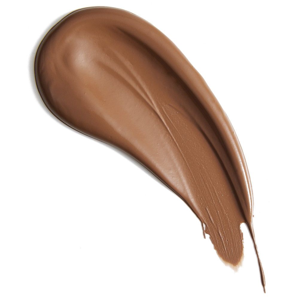 Nuance de correcteur brun sur fond blanc. Texture crémeuse et lisse.