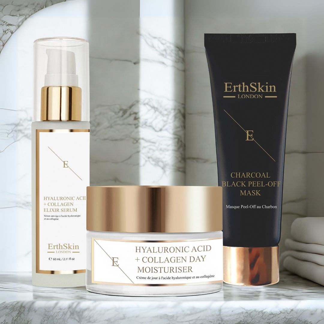 Ensemble sérum, crème de jour et masque. Produits avec détails dorés et étiquettes blanches. Sur surface marbrée.