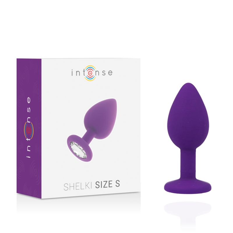 Plug anal violet et son emballage. Plug avec cristal sur la bride. L'emballage indique 'Shelki Size S'.