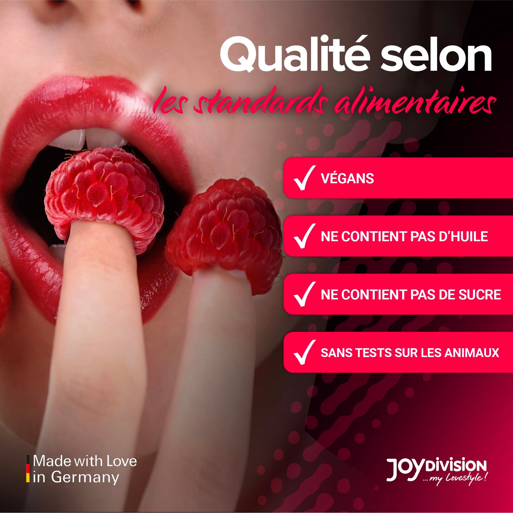 Bouteille d'huile de massage framboise, entourée de framboises.